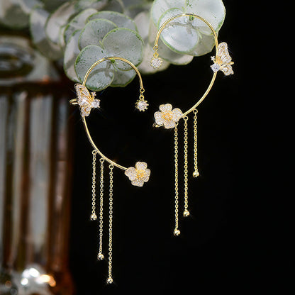 Elegante øreringer med sommerfuglblomst og dusker